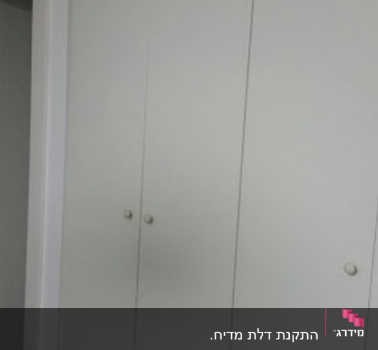 ארון בגדים לבן עם דלתות סגורות